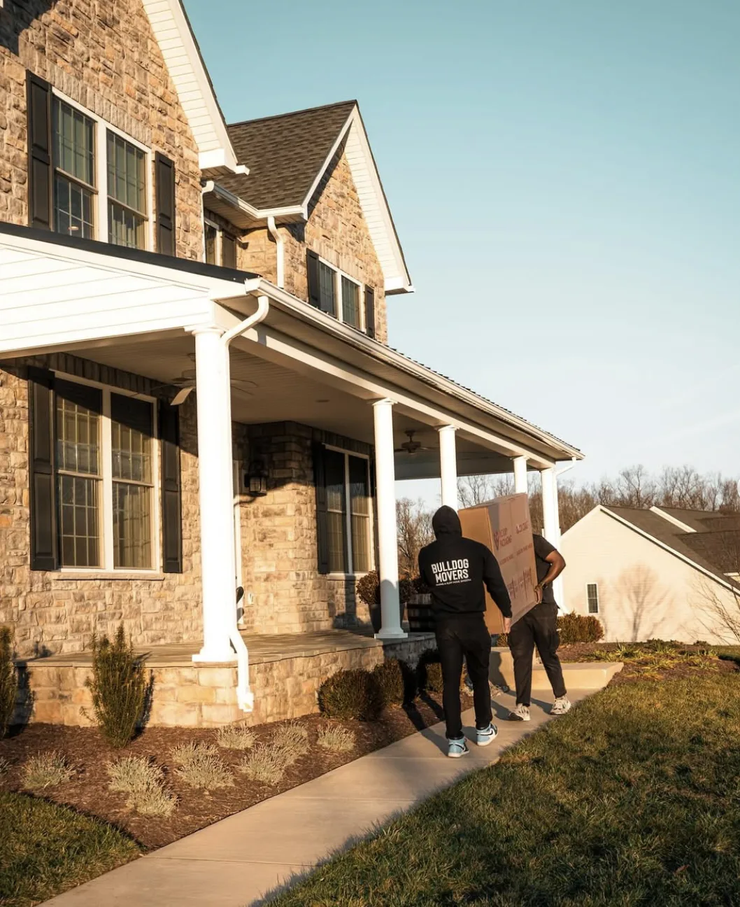 Moving crew walking toward a residential entrance