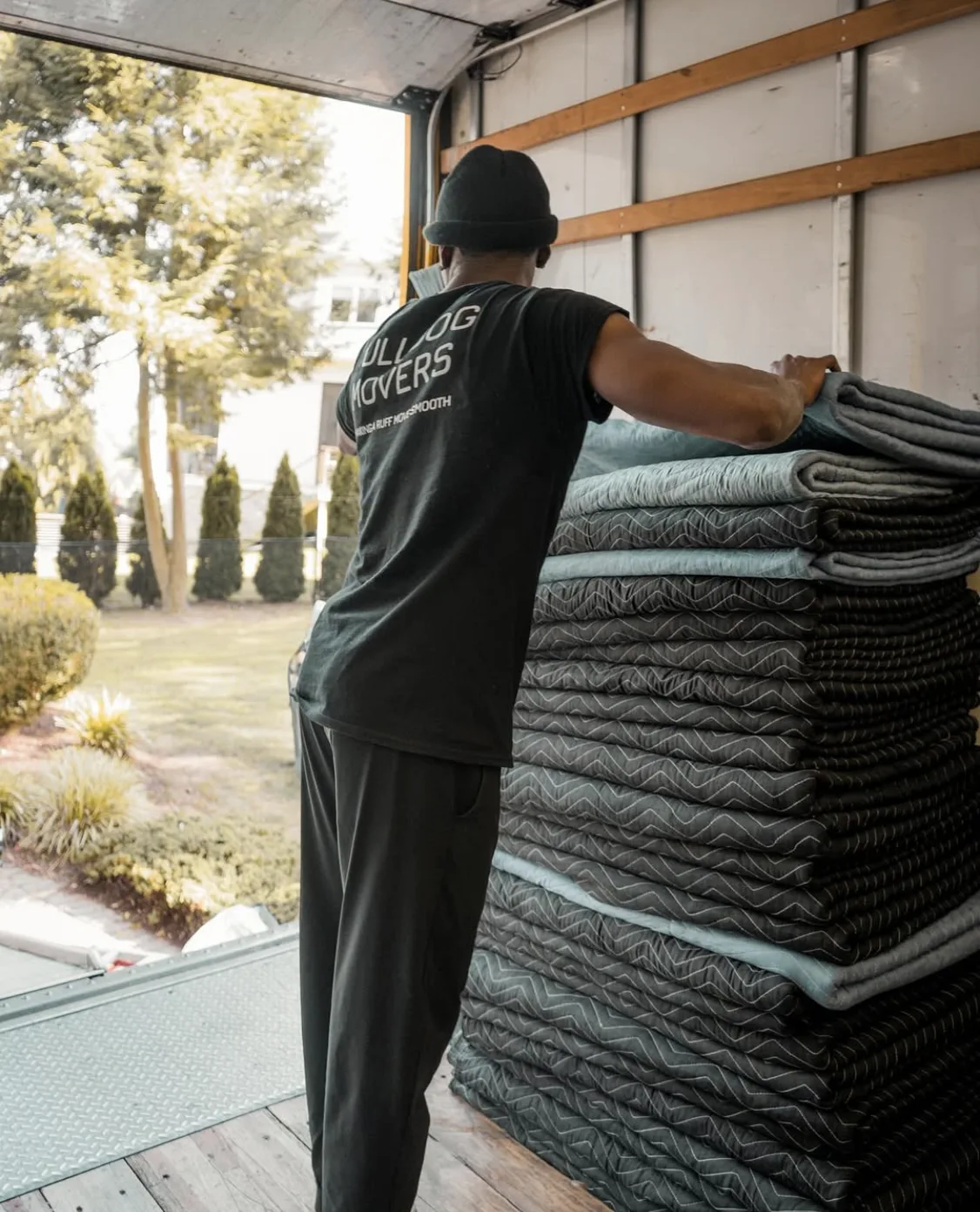 Mover stacking moving blankets inside a truck