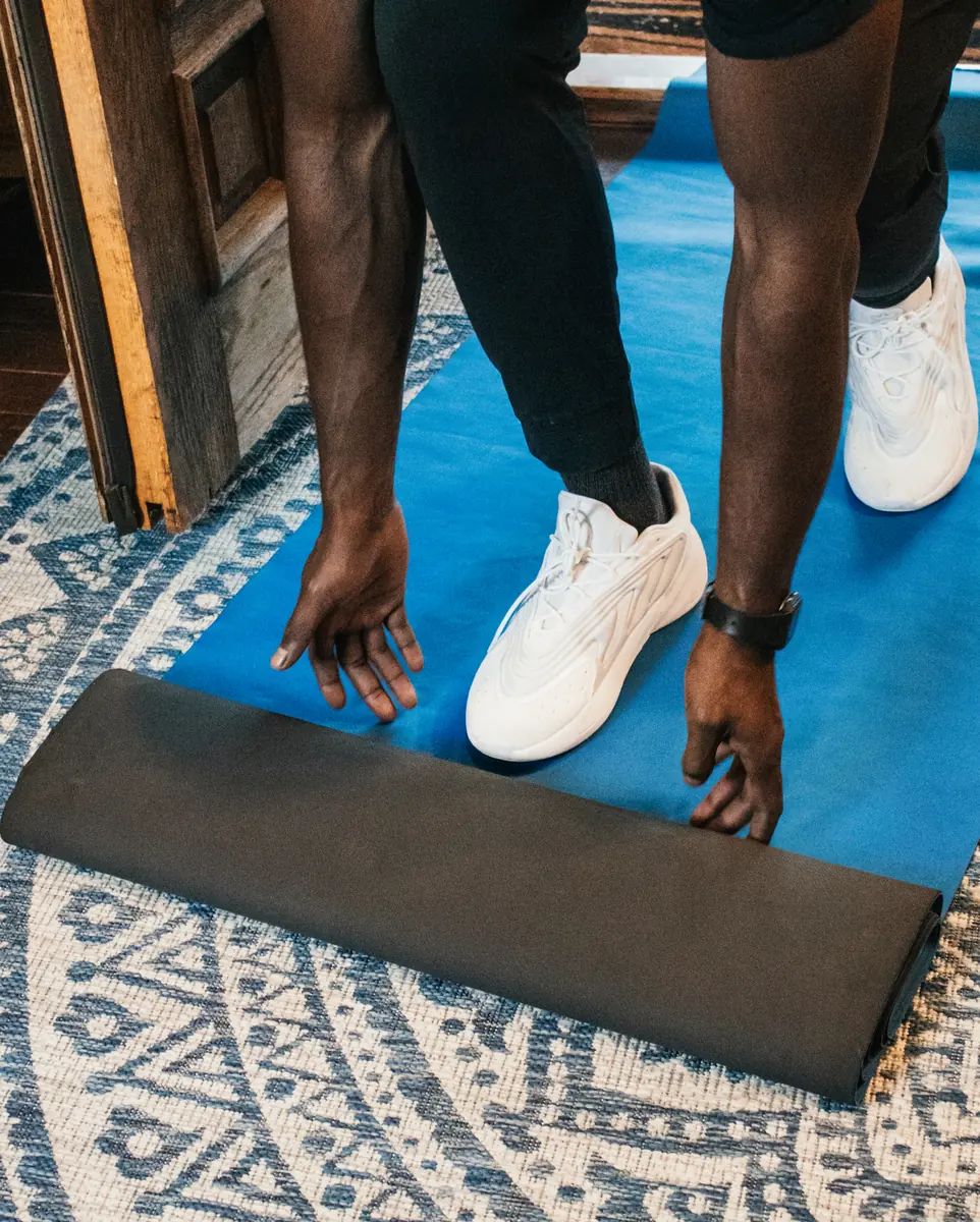 Mover placing floor protection mat inside an apartment entry