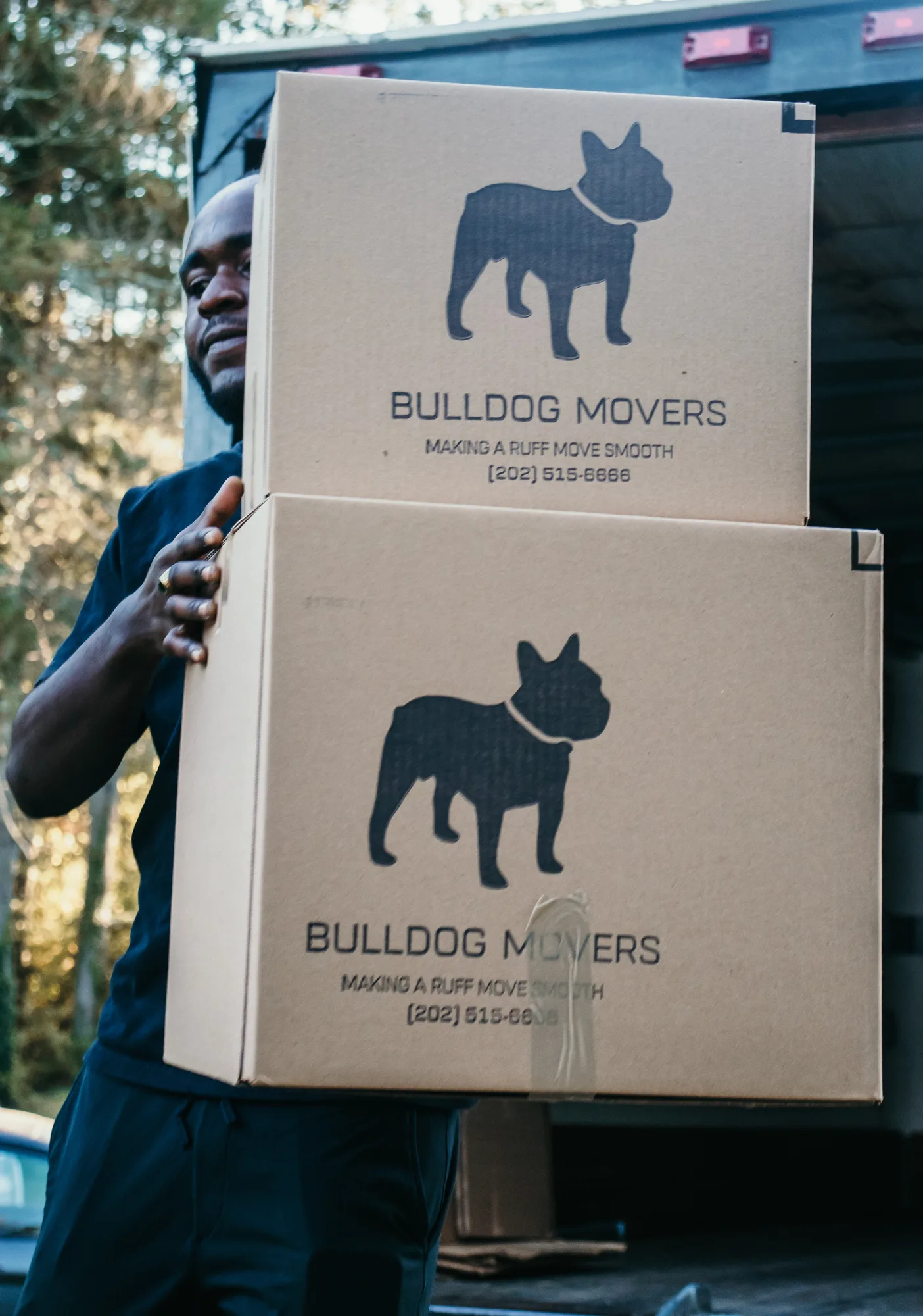 Mover carrying stacked branded boxes for a Rockville packing project