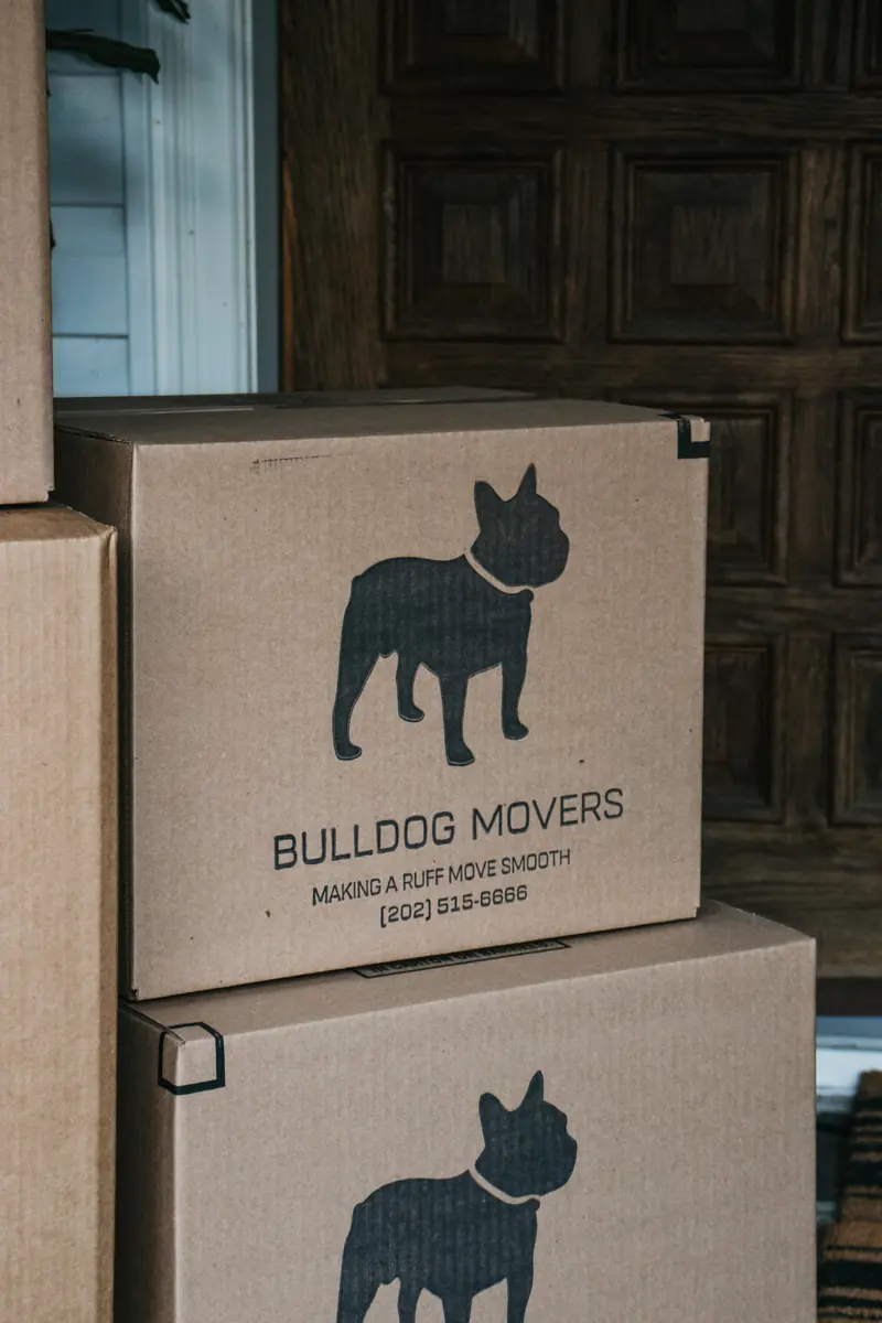 Close-up stack of branded moving boxes near an entryway